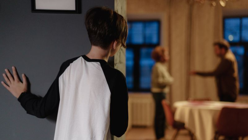 a boy watching his parents quarrel